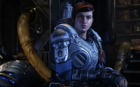 Kait Diaz w zbroi z Gears of War 5, z warkoczem i czerwoną opaską na włosach, w tle industrialne otoczenie.